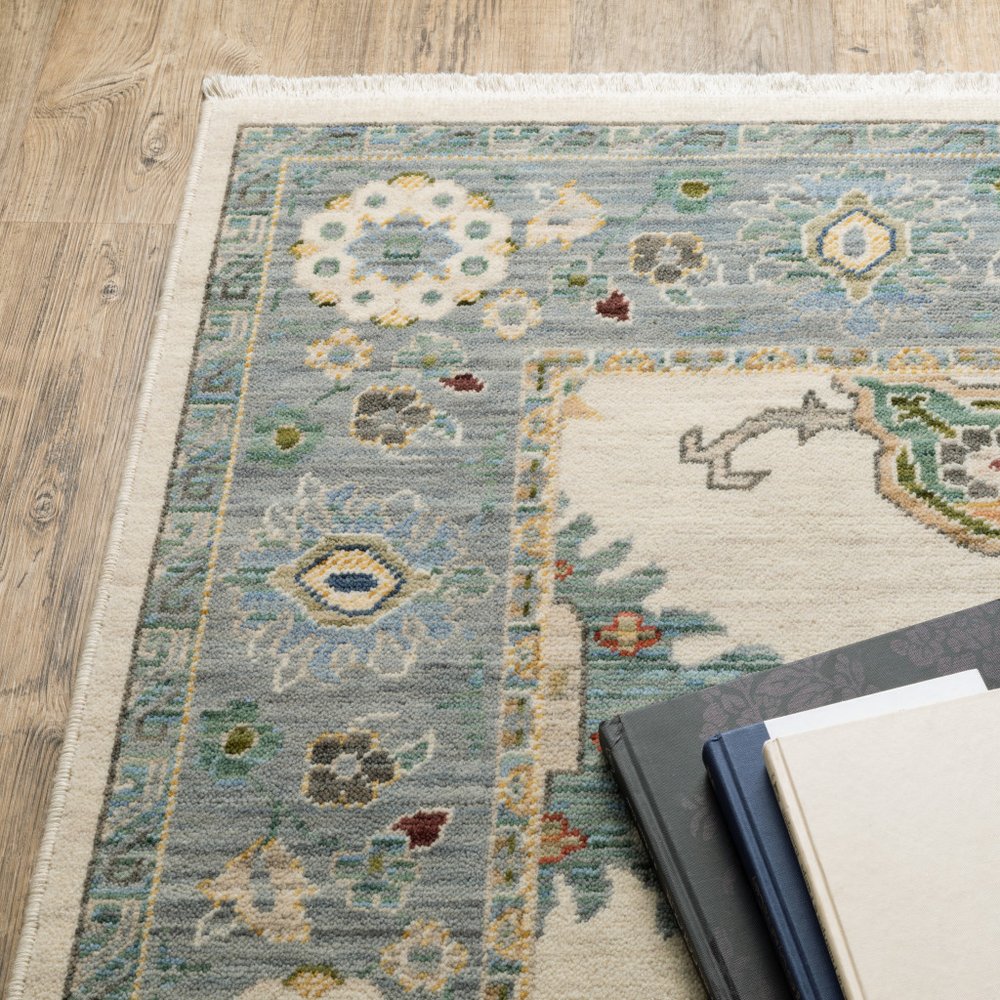2' X 3' Ivory Blue Grey Teal Gold Green And Rust Oriental Power Loom Stain Resistant Area Rug With Fringe