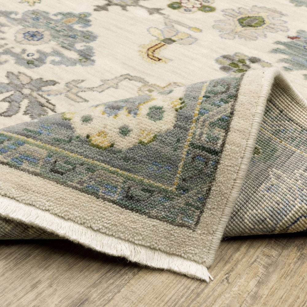 2' X 3' Ivory Blue Grey Teal Gold Green And Rust Oriental Power Loom Stain Resistant Area Rug With Fringe