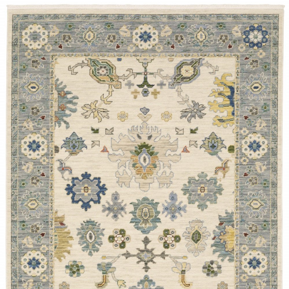 10' X 13' Ivory Blue Grey Teal Gold Green And Rust Oriental Power Loom Stain Resistant Area Rug With Fringe