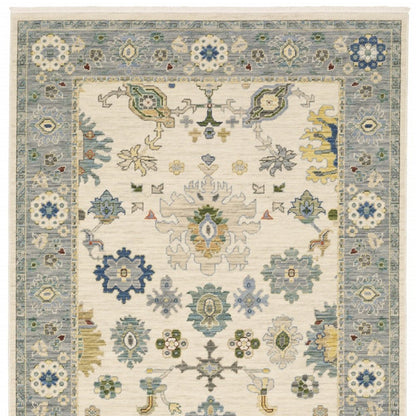 10' X 13' Ivory Blue Grey Teal Gold Green And Rust Oriental Power Loom Stain Resistant Area Rug With Fringe