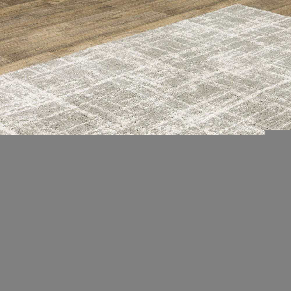 5' X 8' Grey And Ivory Abstract Shag Power Loom Stain Resistant Area Rug