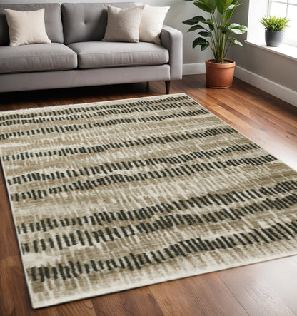 5' X 8' Beige Ivory Charcoal Brown Tan And Grey Abstract Power Loom Stain Resistant Area Rug With Fringe