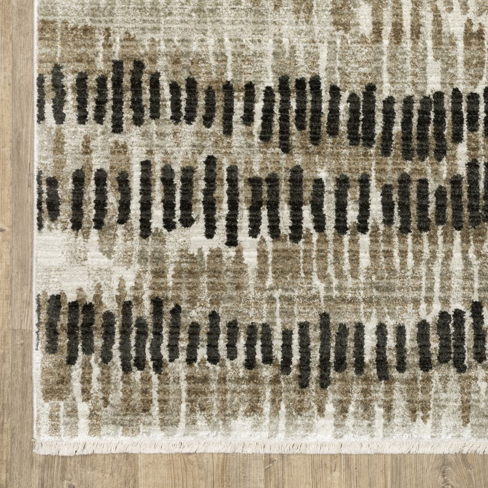 5' X 8' Beige Ivory Charcoal Brown Tan And Grey Abstract Power Loom Stain Resistant Area Rug With Fringe