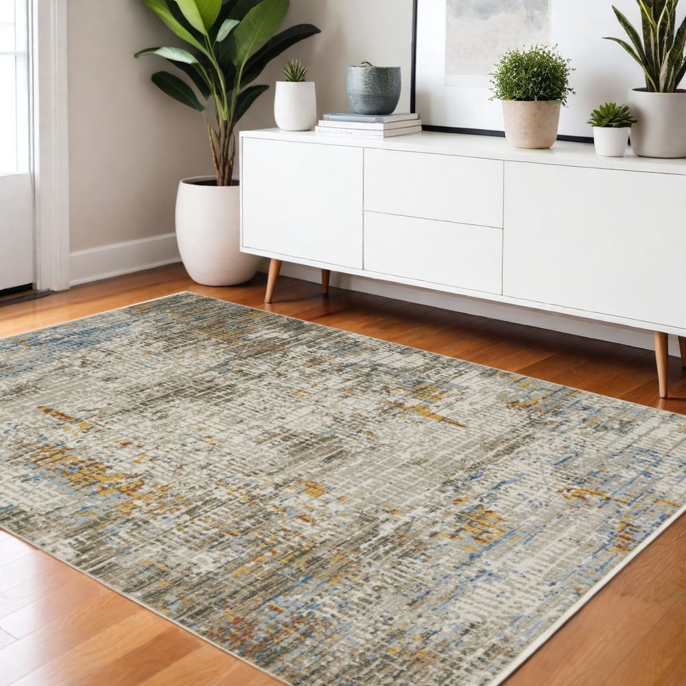 4' X 6' Beige Grey Brown Gold Red And Blue Abstract Power Loom Stain Resistant Area Rug With Fringe
