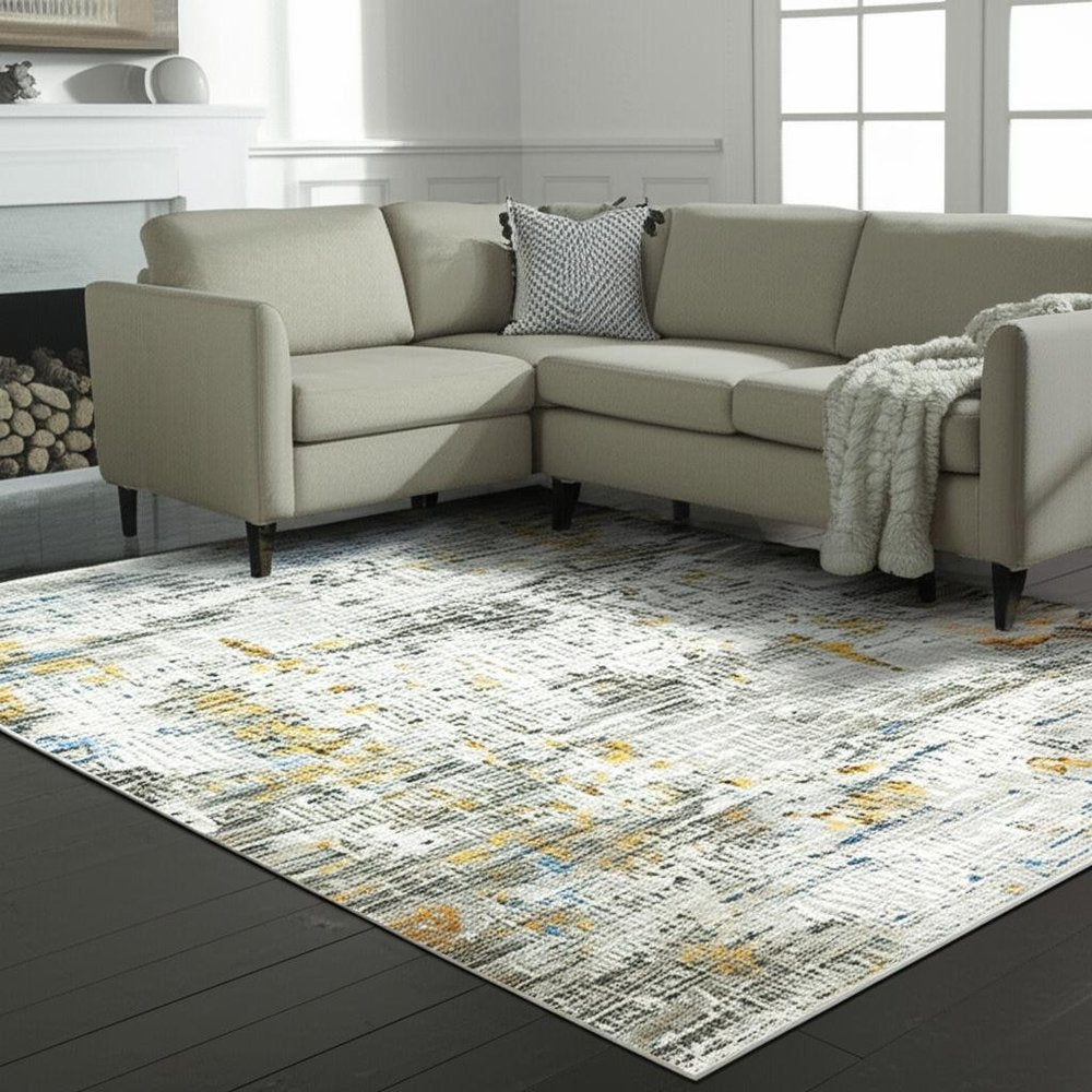 5' X 8' Beige Grey Brown Gold Red And Blue Abstract Power Loom Stain Resistant Area Rug With Fringe