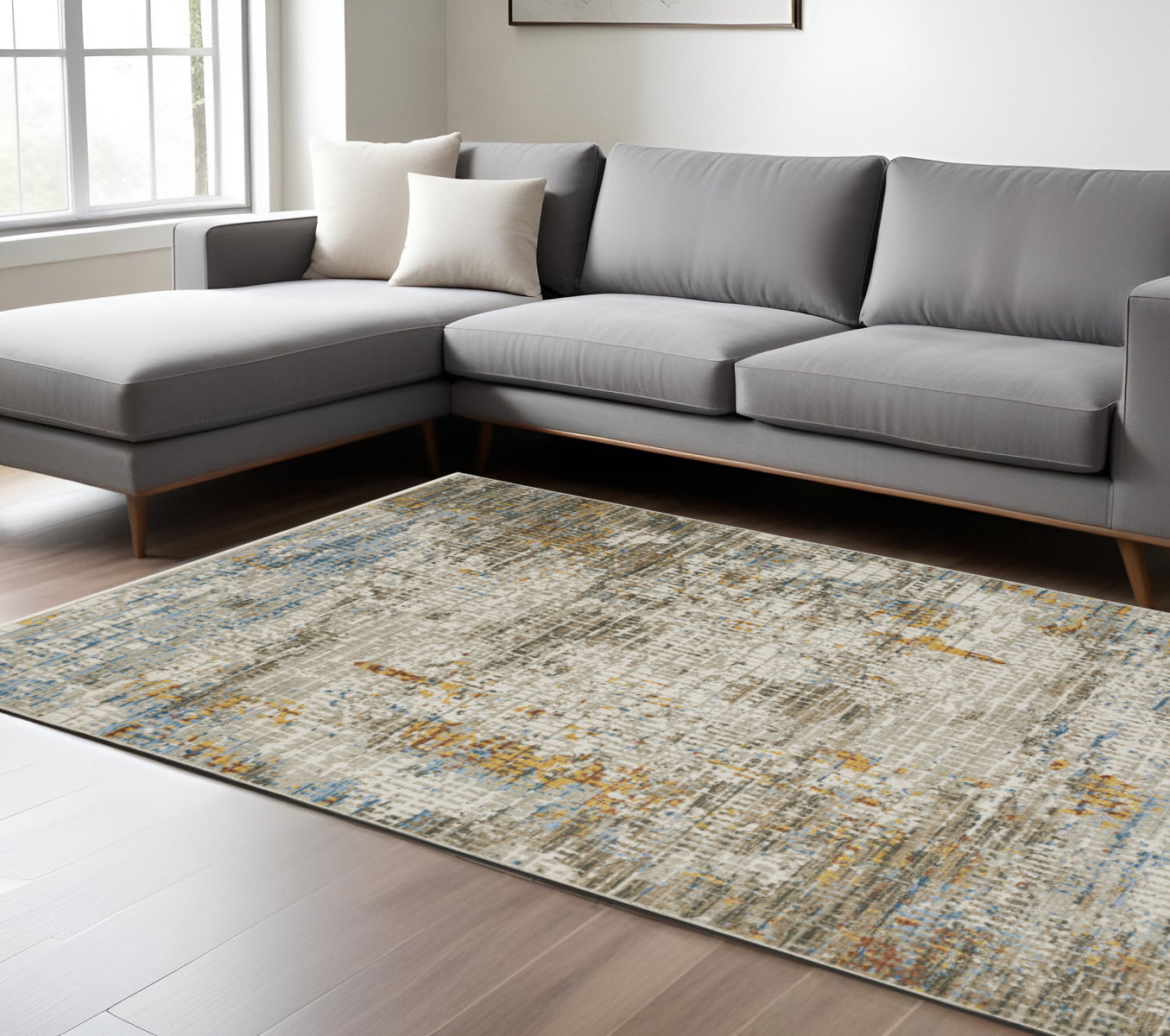 6' X 9' Beige Grey Brown Gold Red And Blue Abstract Power Loom Stain Resistant Area Rug With Fringe