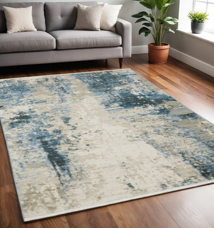 5' X 8' Blue Grey Ivory Light Blue And Dark Blue Abstract Power Loom Stain Resistant Area Rug With Fringe