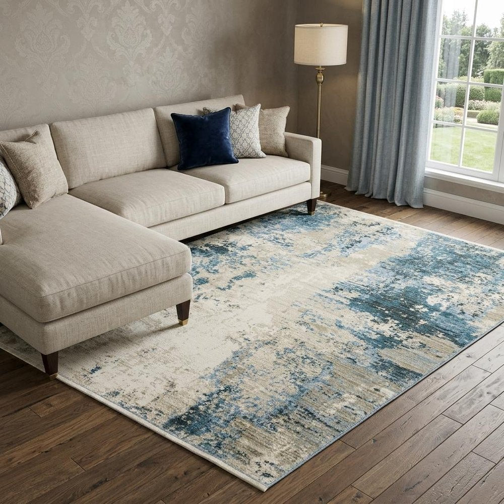 6' X 9' Blue Grey Ivory Light Blue And Dark Blue Abstract Power Loom Stain Resistant Area Rug With Fringe