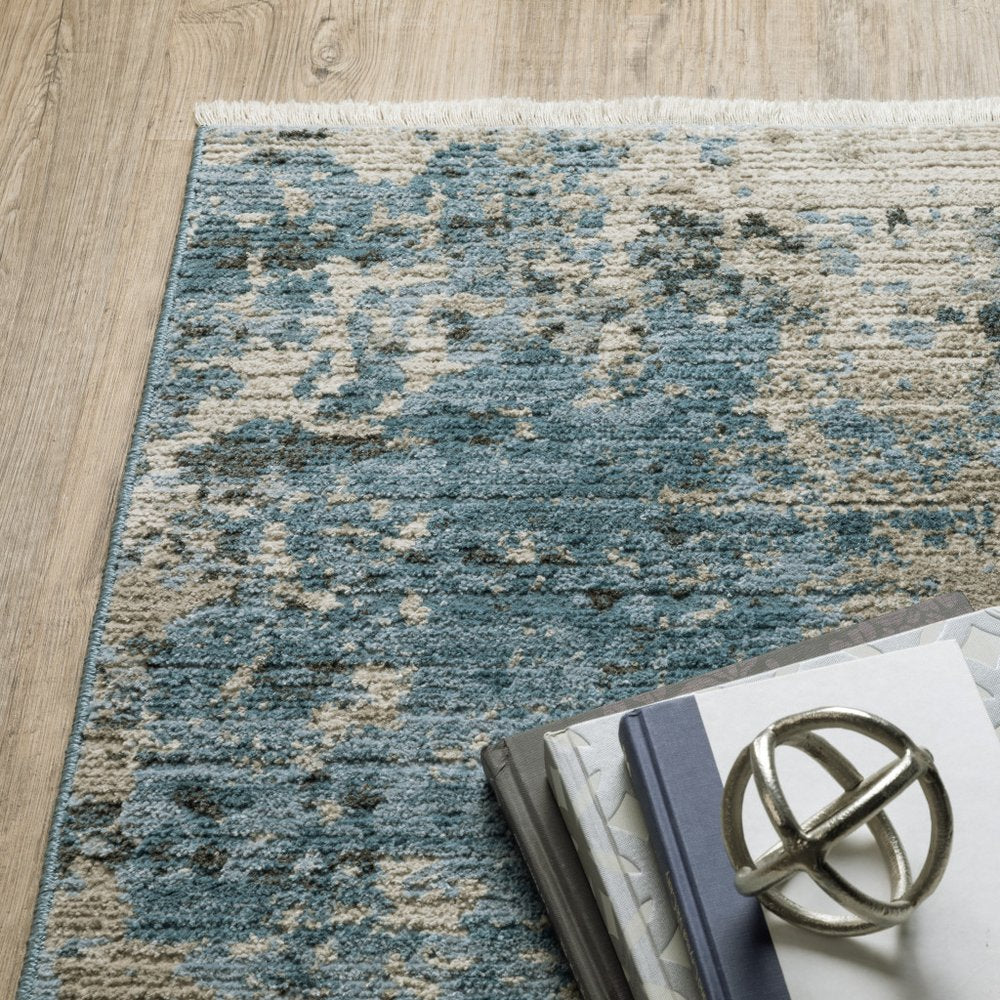 8' X 11' Blue Grey Ivory Light Blue And Dark Blue Abstract Power Loom Stain Resistant Area Rug With Fringe