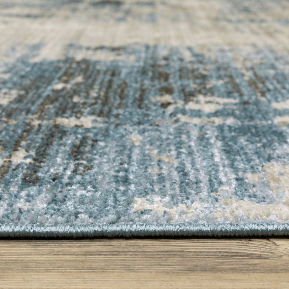 8' X 11' Blue Grey Ivory Light Blue And Dark Blue Abstract Power Loom Stain Resistant Area Rug With Fringe