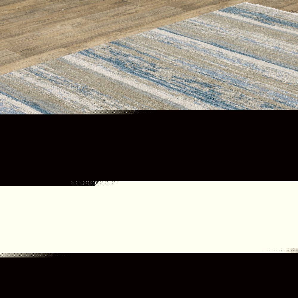 5' X 8' Ivory Beige Grey Blue And Tan Abstract Power Loom Stain Resistant Area Rug With Fringe