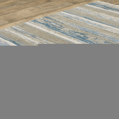 5' X 8' Ivory Beige Grey Blue And Tan Abstract Power Loom Stain Resistant Area Rug With Fringe