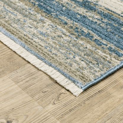 6' X 9' Ivory Beige Grey Blue And Tan Abstract Power Loom Stain Resistant Area Rug With Fringe