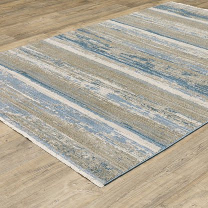 6' X 9' Ivory Beige Grey Blue And Tan Abstract Power Loom Stain Resistant Area Rug With Fringe