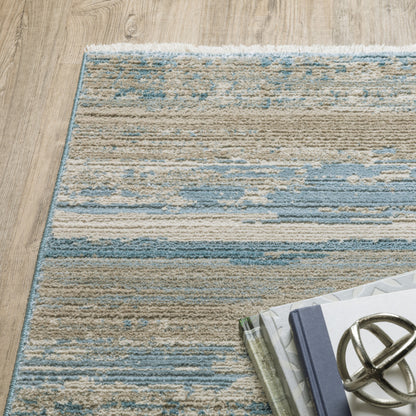 6' X 9' Ivory Beige Grey Blue And Tan Abstract Power Loom Stain Resistant Area Rug With Fringe