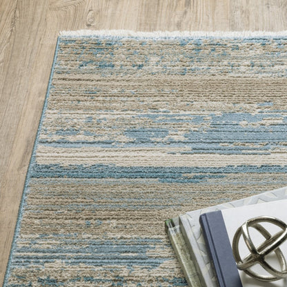 6' X 9' Ivory Beige Grey Blue And Tan Abstract Power Loom Stain Resistant Area Rug With Fringe
