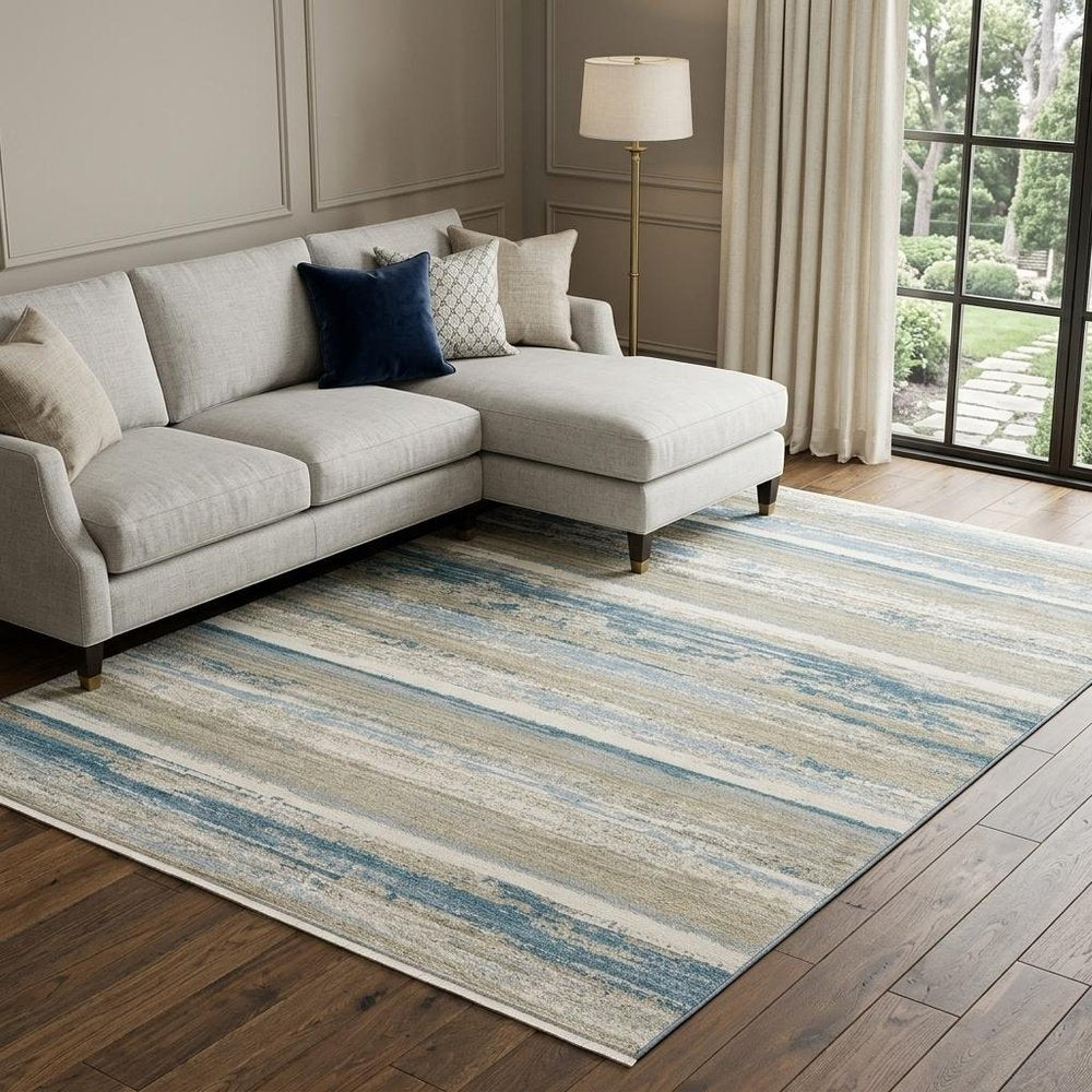 8' X 11' Ivory Beige Grey Blue And Tan Abstract Power Loom Stain Resistant Area Rug With Fringe