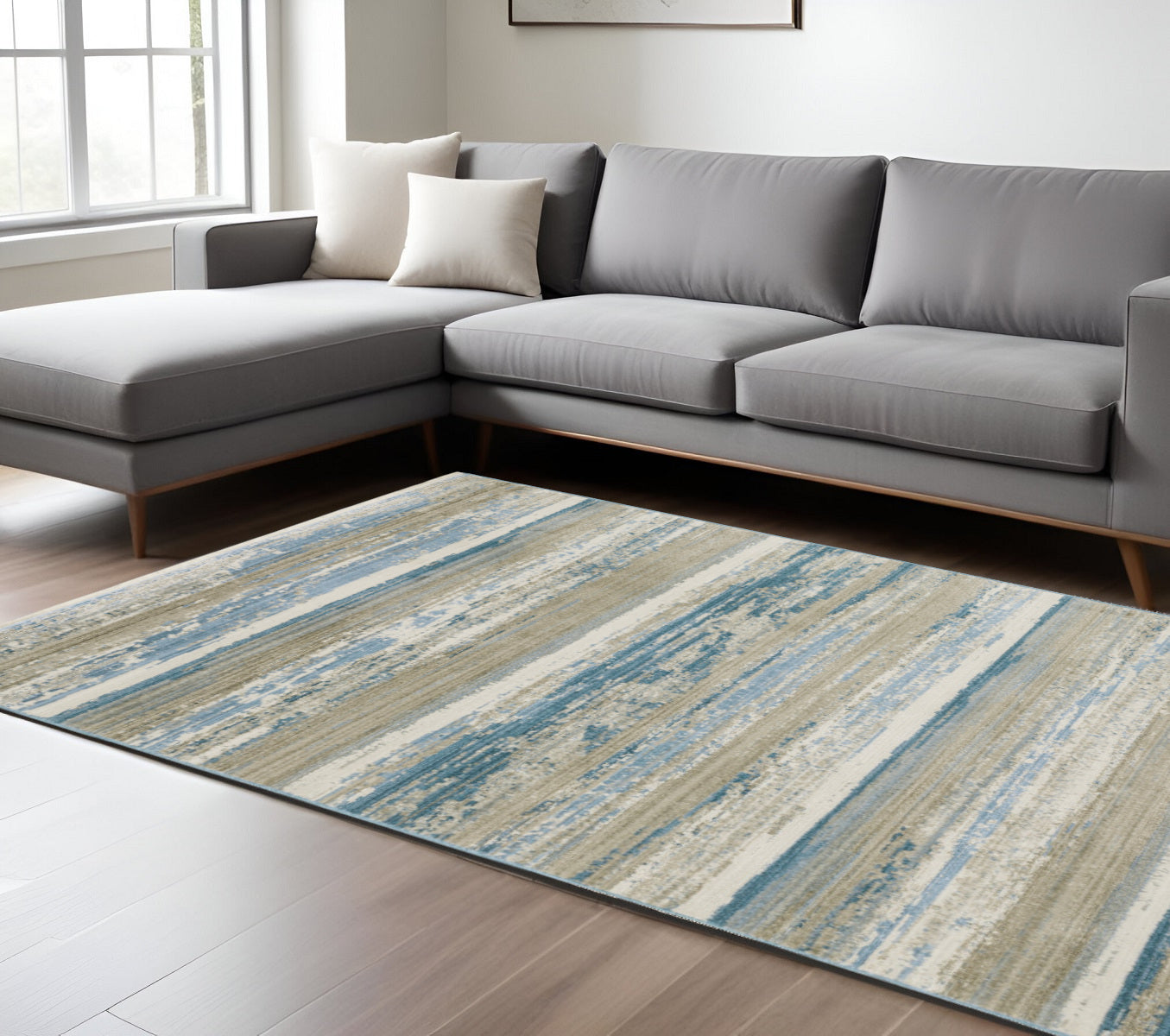 8' X 11' Ivory Beige Grey Blue And Tan Abstract Power Loom Stain Resistant Area Rug With Fringe