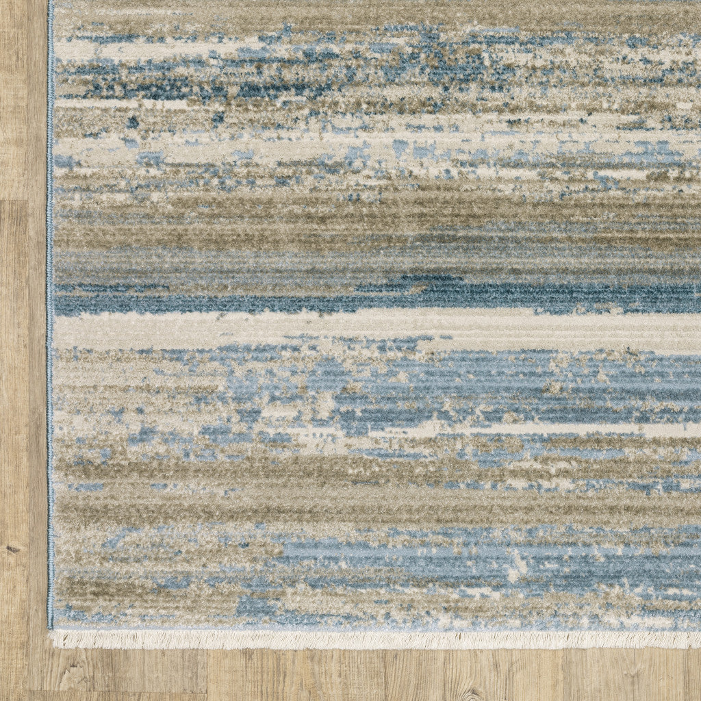 8' X 11' Ivory Beige Grey Blue And Tan Abstract Power Loom Stain Resistant Area Rug With Fringe