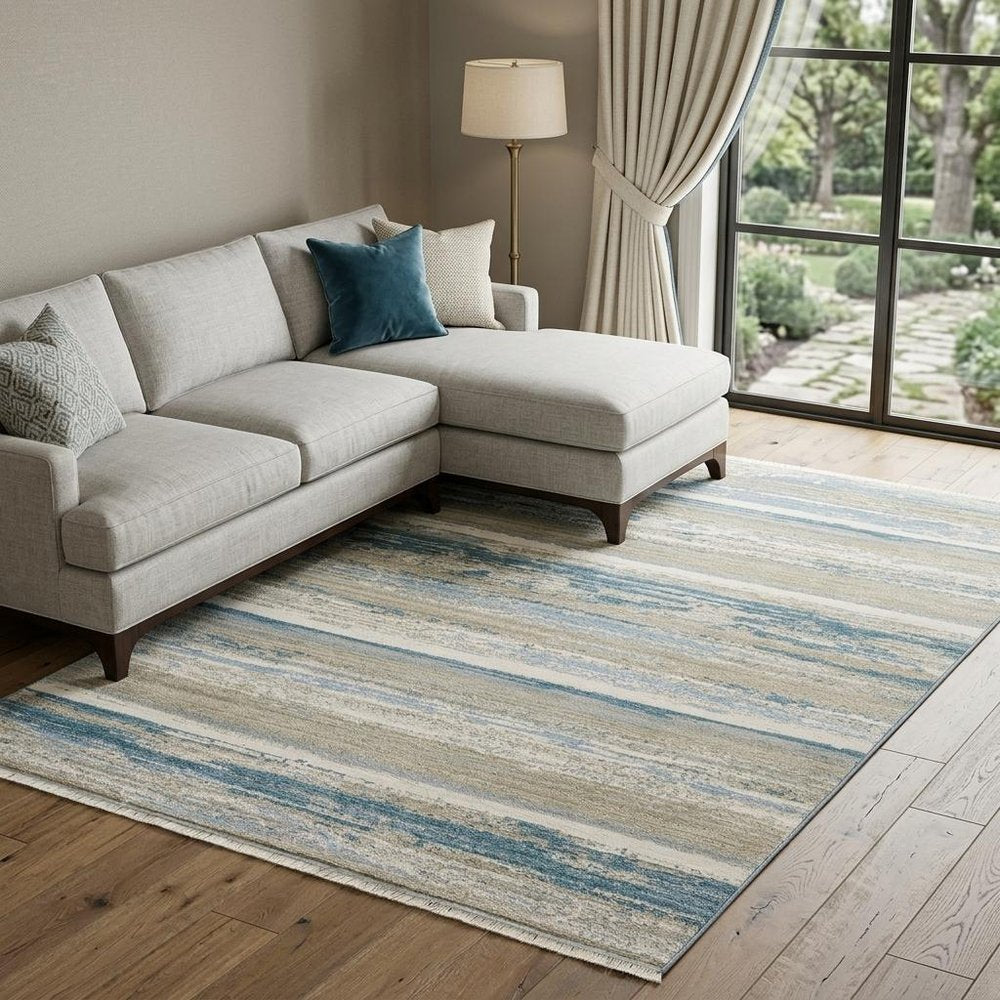 10' X 13' Ivory Beige Grey Blue And Tan Abstract Power Loom Stain Resistant Area Rug With Fringe