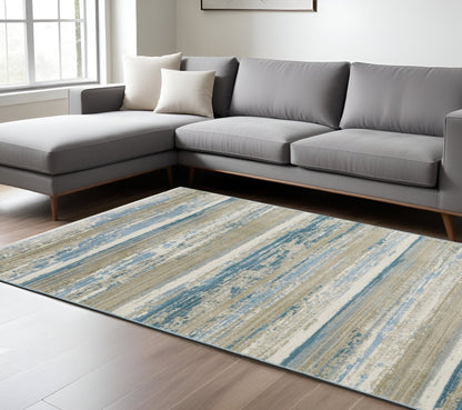 10' X 13' Ivory Beige Grey Blue And Tan Abstract Power Loom Stain Resistant Area Rug With Fringe