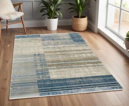 4' X 6' Blue Dark Blue Teal Grey Ivory Beige And Tan Geometric Power Loom Stain Resistant Area Rug With Fringe