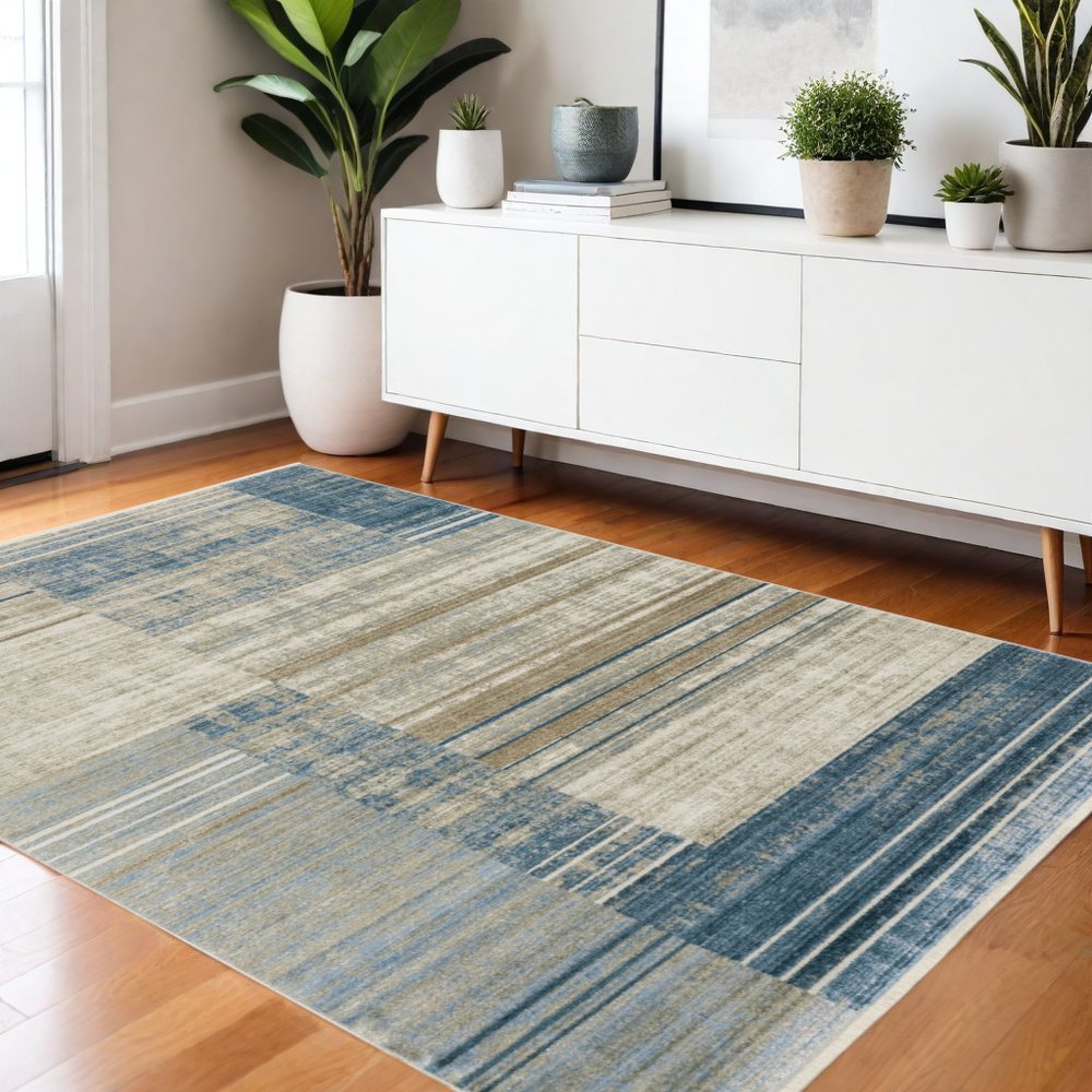 4' X 6' Blue Dark Blue Teal Grey Ivory Beige And Tan Geometric Power Loom Stain Resistant Area Rug With Fringe