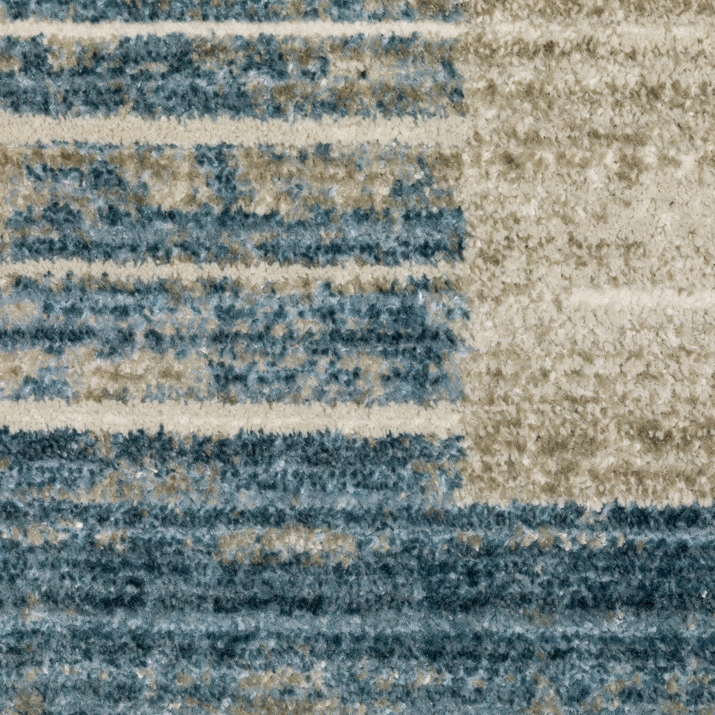 4' X 6' Blue Dark Blue Teal Grey Ivory Beige And Tan Geometric Power Loom Stain Resistant Area Rug With Fringe