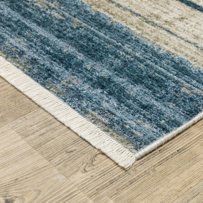 5' X 8' Blue Dark Blue Teal Grey Ivory Beige And Tan Geometric Power Loom Stain Resistant Area Rug With Fringe