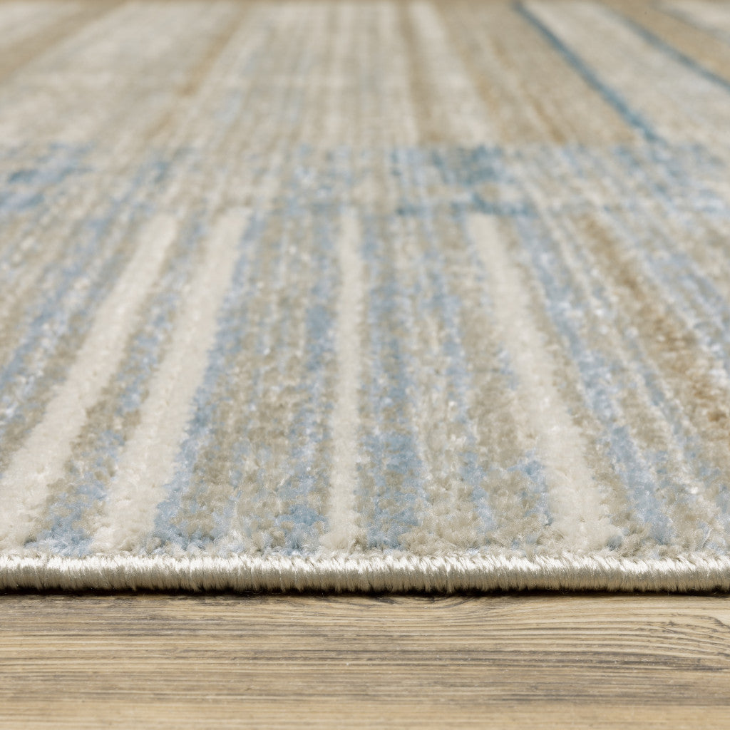 5' X 8' Blue Dark Blue Teal Grey Ivory Beige And Tan Geometric Power Loom Stain Resistant Area Rug With Fringe