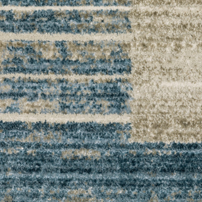 5' X 8' Blue Dark Blue Teal Grey Ivory Beige And Tan Geometric Power Loom Stain Resistant Area Rug With Fringe