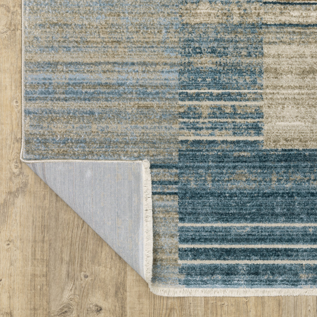 5' X 8' Blue Dark Blue Teal Grey Ivory Beige And Tan Geometric Power Loom Stain Resistant Area Rug With Fringe