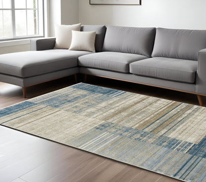 6' X 9' Blue Dark Blue Teal Grey Ivory Beige And Tan Geometric Power Loom Stain Resistant Area Rug With Fringe