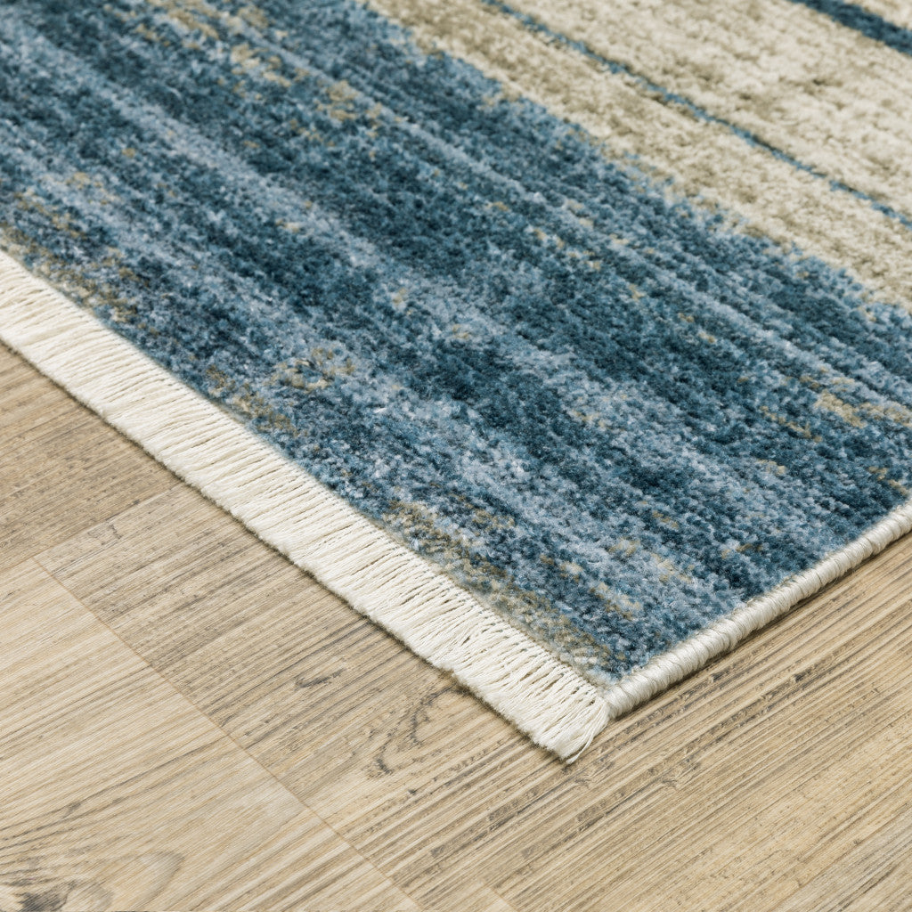 6' X 9' Blue Dark Blue Teal Grey Ivory Beige And Tan Geometric Power Loom Stain Resistant Area Rug With Fringe