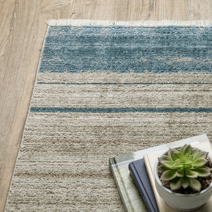 6' X 9' Blue Dark Blue Teal Grey Ivory Beige And Tan Geometric Power Loom Stain Resistant Area Rug With Fringe