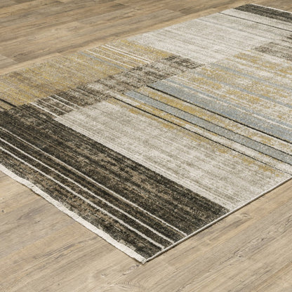 6' X 9' Beige Charcoal Brown Grey Tan Gold And Blue Geometric Power Loom Stain Resistant Area Rug With Fringe