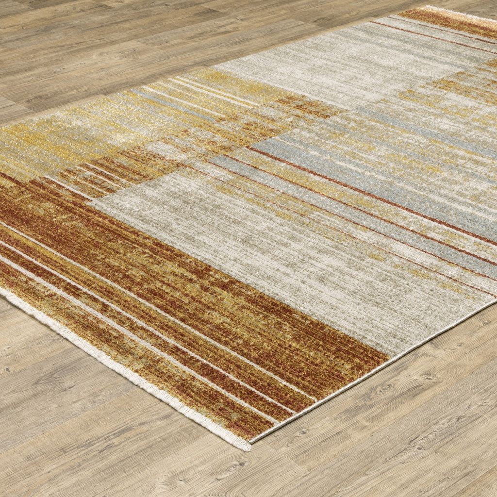 6' X 9' Rust Gold Blue Grey Ivory And Tan Geometric Power Loom Stain Resistant Area Rug With Fringe