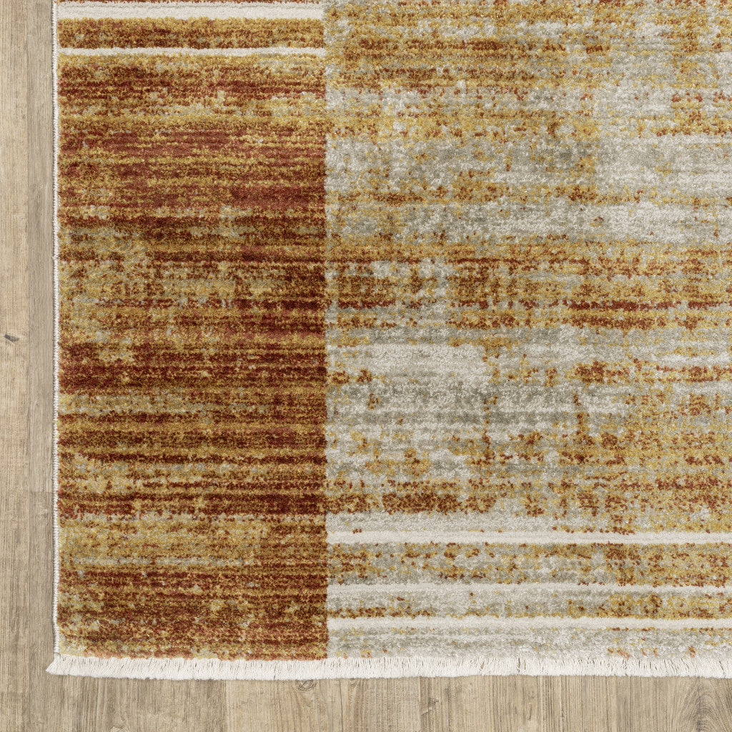 6' X 9' Rust Gold Blue Grey Ivory And Tan Geometric Power Loom Stain Resistant Area Rug With Fringe