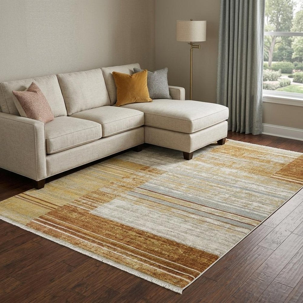 8' X 11' Rust Gold Blue Grey Ivory And Tan Geometric Power Loom Stain Resistant Area Rug With Fringe