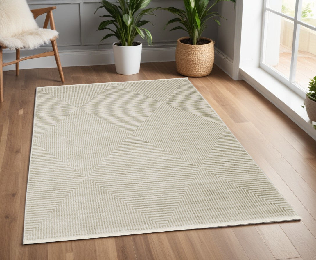 4' X 6' Ivory Beige Taupe And Tan Geometric Power Loom Stain Resistant Area Rug With Fringe