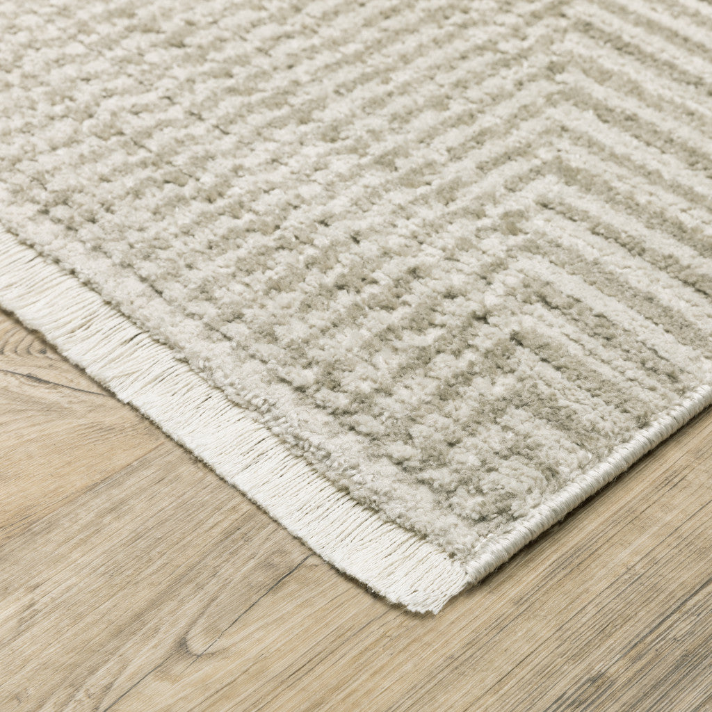 4' X 6' Ivory Beige Taupe And Tan Geometric Power Loom Stain Resistant Area Rug With Fringe