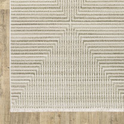 4' X 6' Ivory Beige Taupe And Tan Geometric Power Loom Stain Resistant Area Rug With Fringe