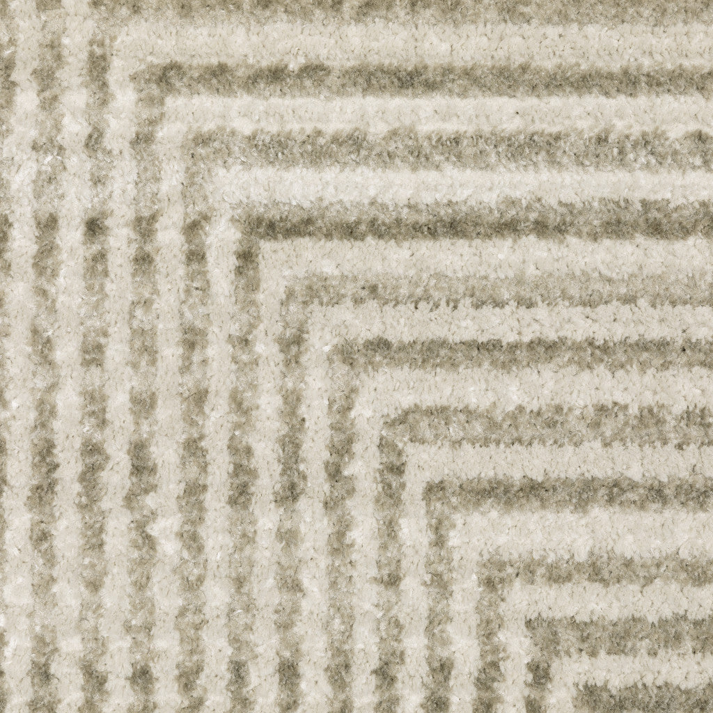 5' X 8' Ivory Beige Taupe And Tan Geometric Power Loom Stain Resistant Area Rug With Fringe