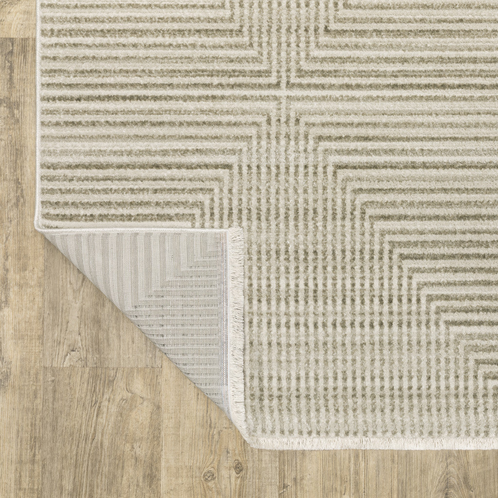 5' X 8' Ivory Beige Taupe And Tan Geometric Power Loom Stain Resistant Area Rug With Fringe