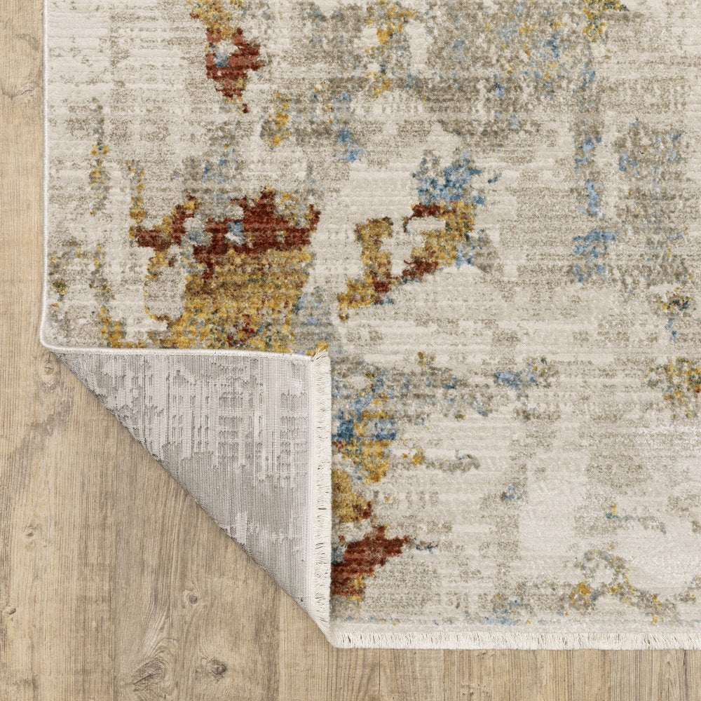 5' X 8' Beige Grey Gold Blue Rust And Teal Abstract Power Loom Stain Resistant Area Rug With Fringe