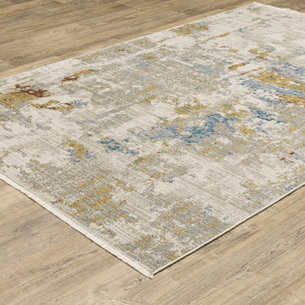 8' X 11' Beige Grey Gold Blue Rust And Teal Abstract Power Loom Stain Resistant Area Rug With Fringe