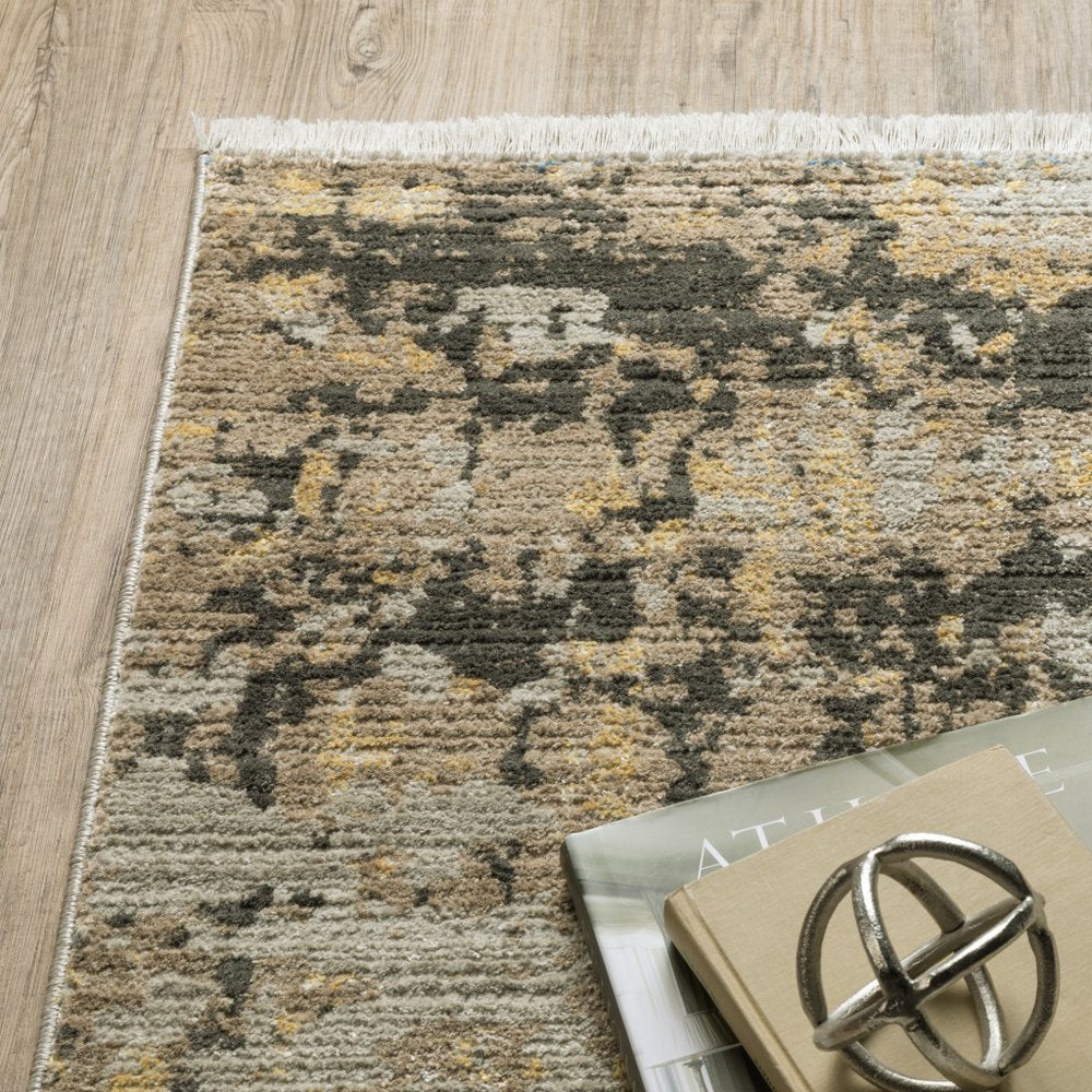 5' X 8' Grey Gold Black Charcoal And Beige Abstract Power Loom Stain Resistant Area Rug With Fringe