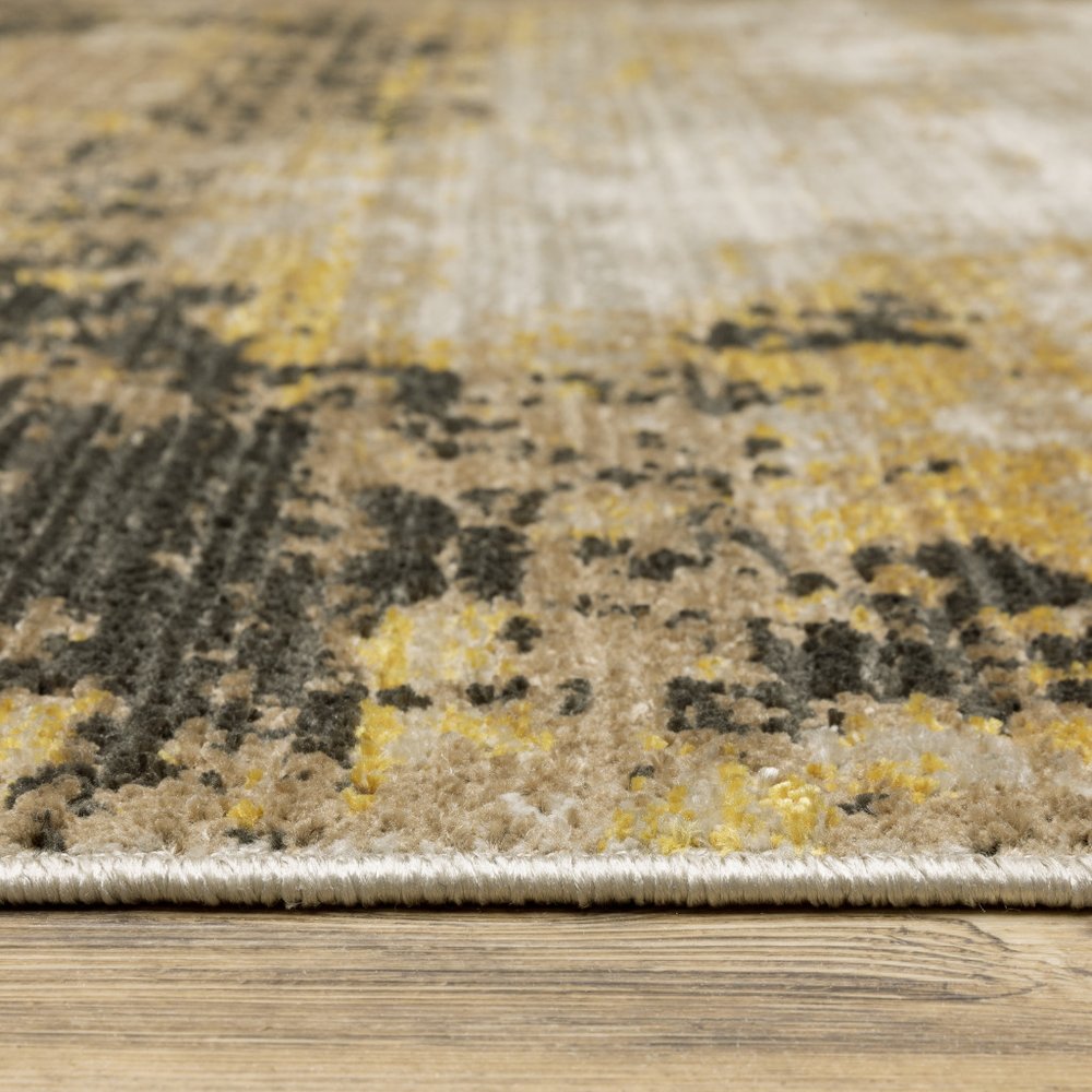 5' X 8' Grey Gold Black Charcoal And Beige Abstract Power Loom Stain Resistant Area Rug With Fringe
