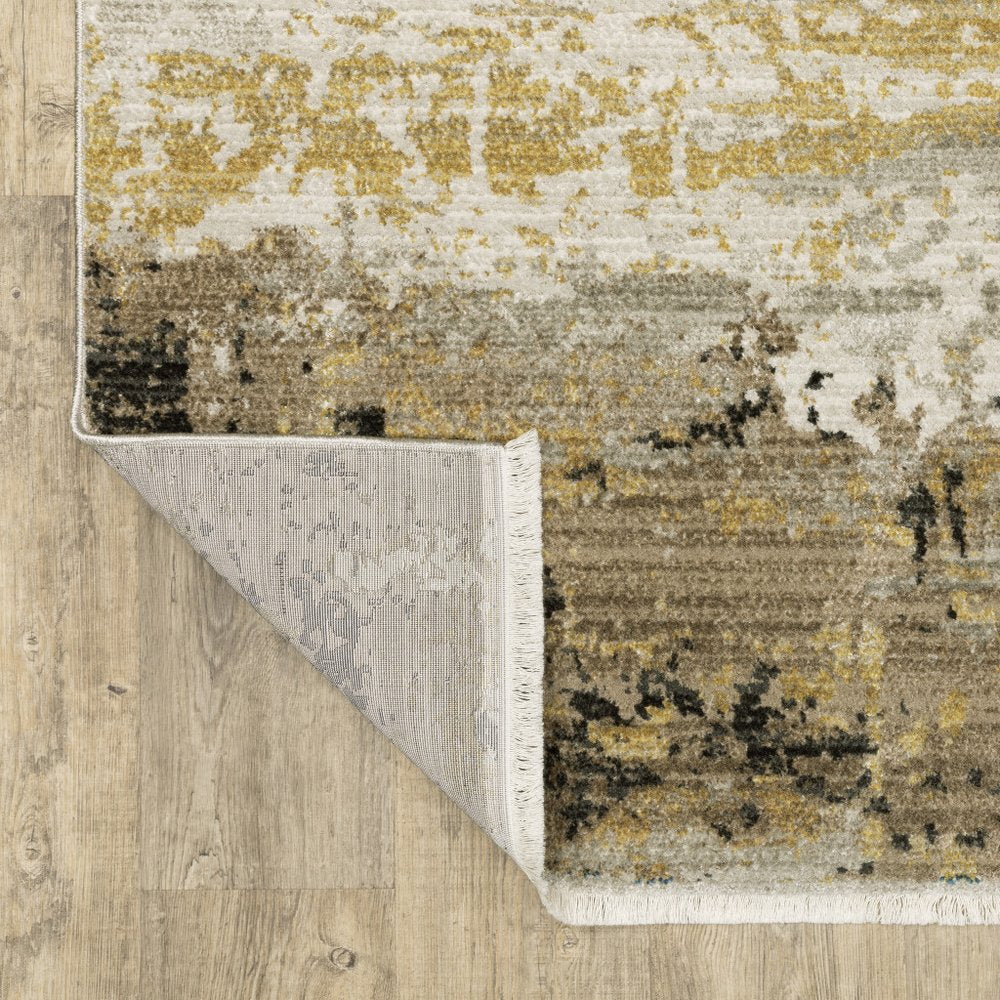 5' X 8' Grey Gold Black Charcoal And Beige Abstract Power Loom Stain Resistant Area Rug With Fringe