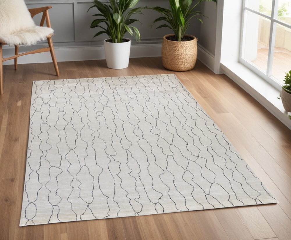 5' X 8' Ivory And Gray Abstract Hand Woven Area Rug